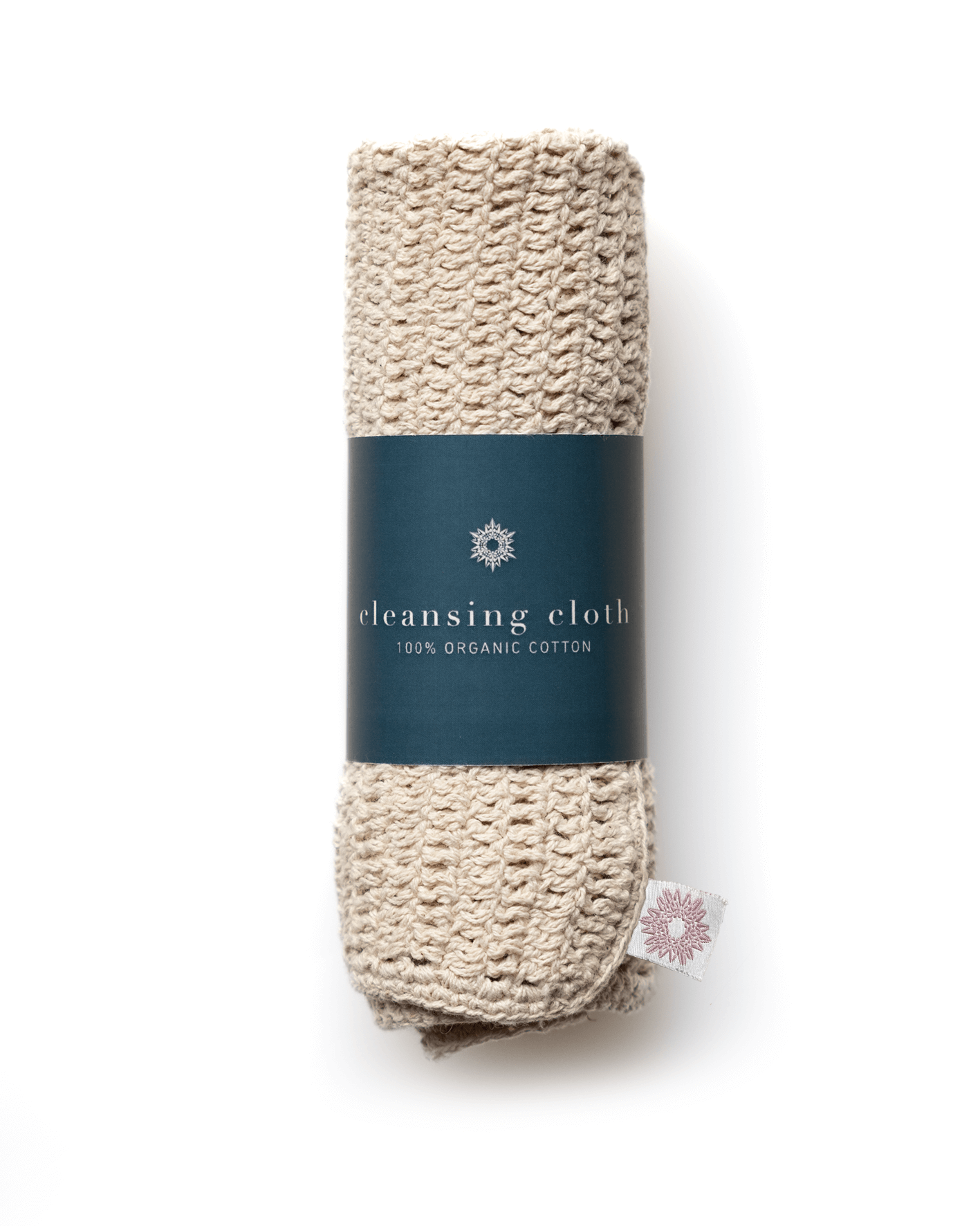 Folded beige cleansing cloth with a teal label on a white background