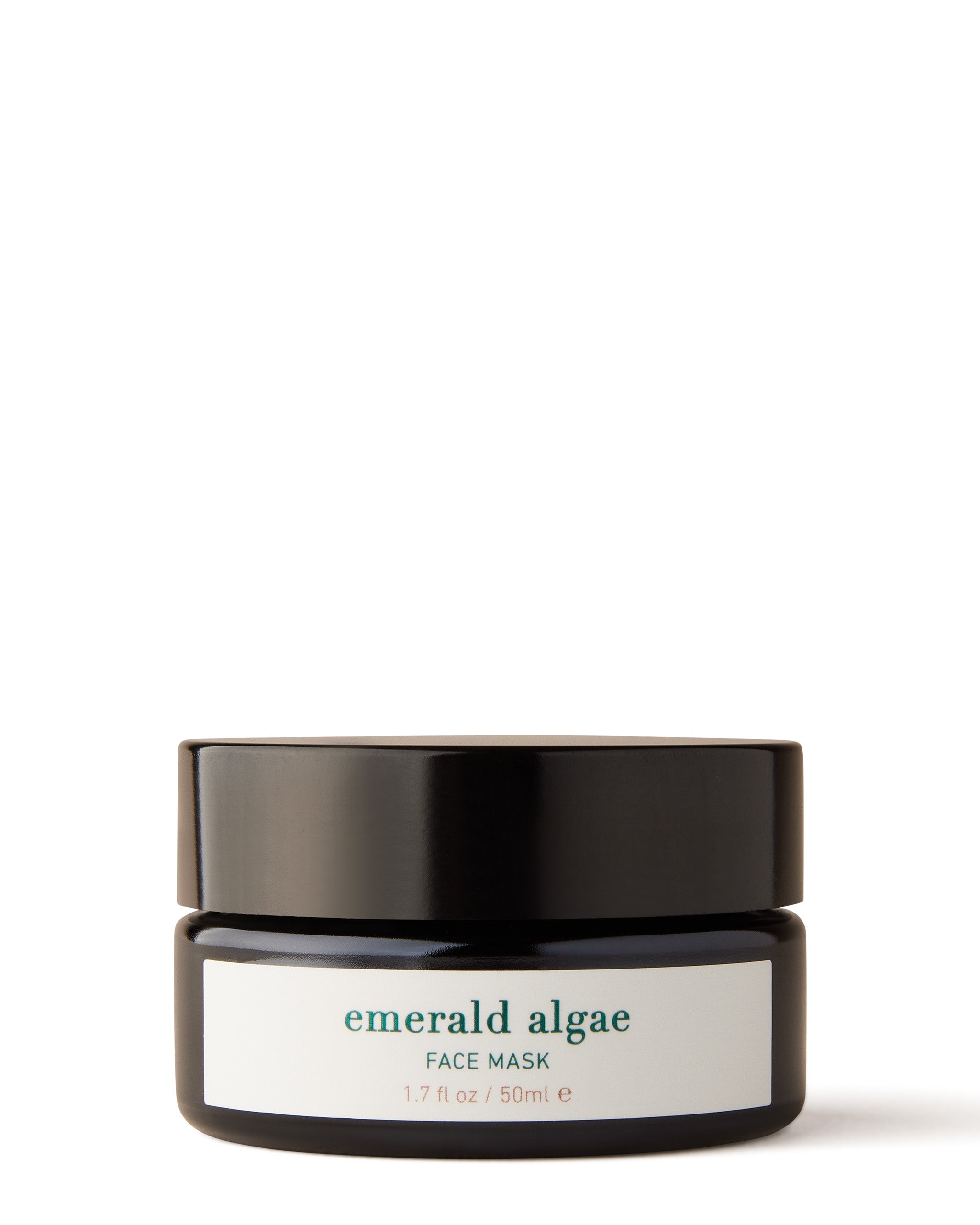 A jar of Emerald Algae Face Mask with a label that includes the product name and a brief description.