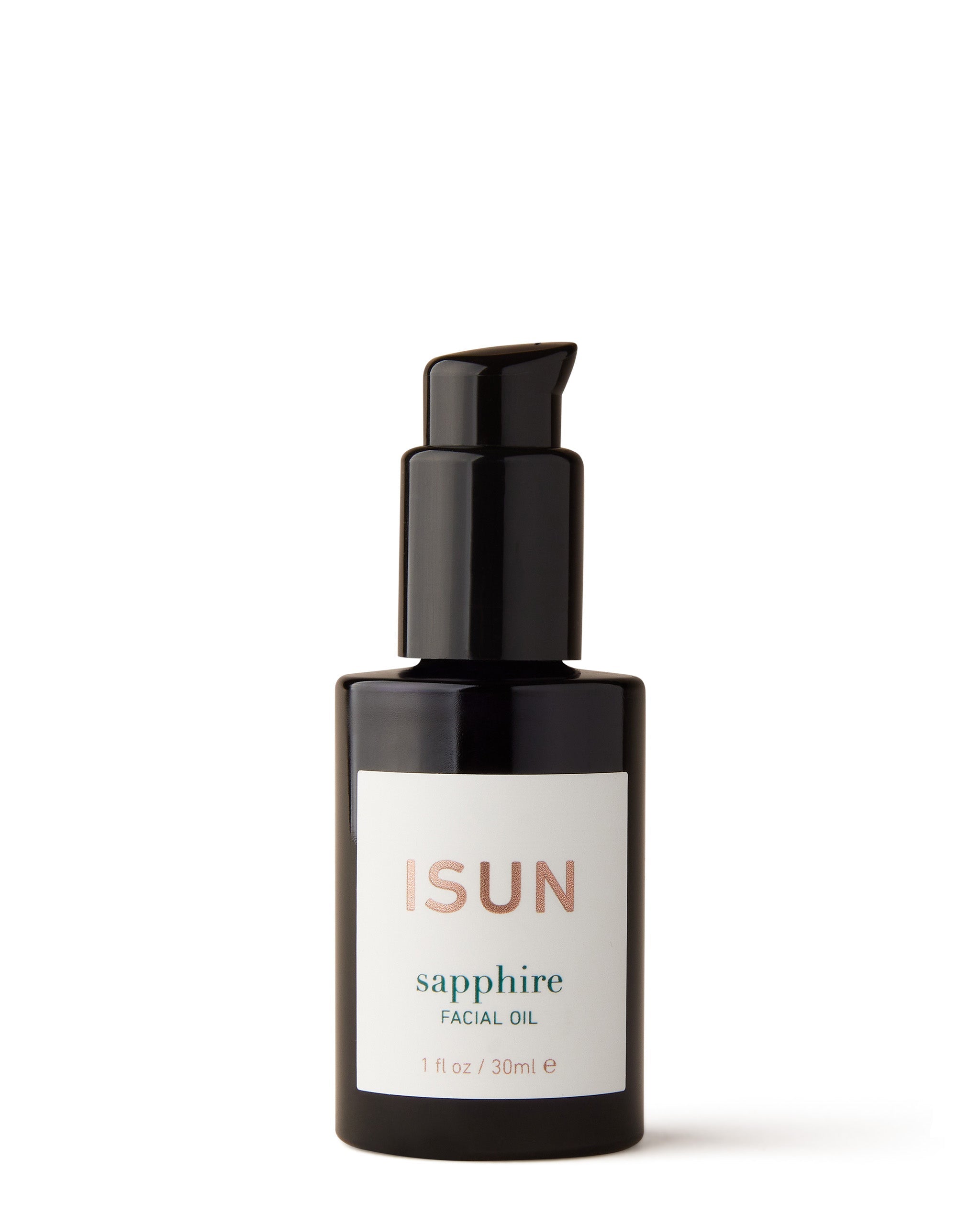 A black bottle with a pump containing Sapphire Facial Oil, with a white label that has the product name and brand 'ISUN' written on it.