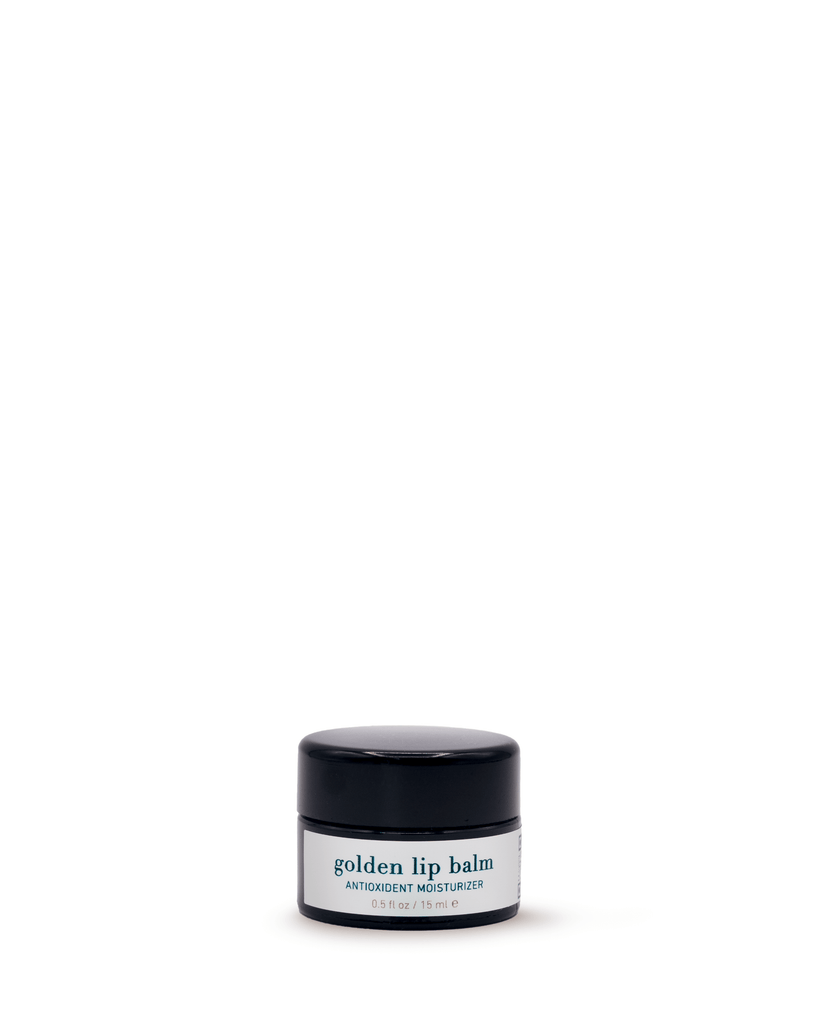 Black lip balm container with a white label on a white background