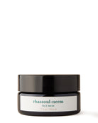 A jar of Rhassoul-Neem Face Mask with a label that includes the product name and a brief description.